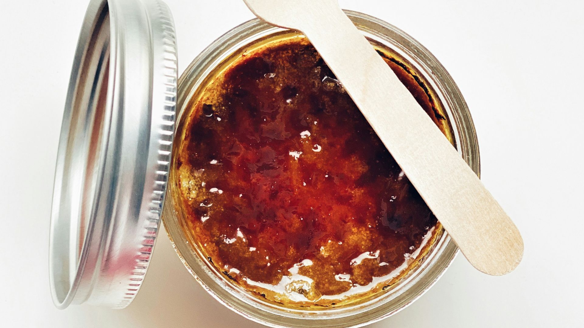 brown liquid in clear glass jar