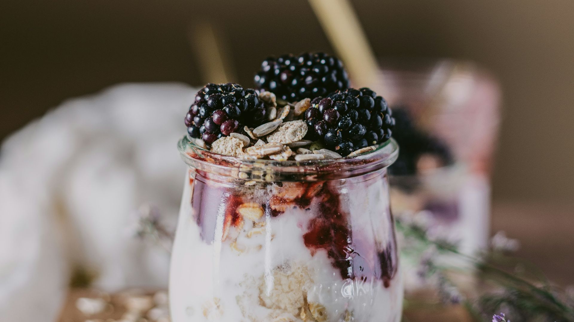 clear drinking glass with ice and black berries