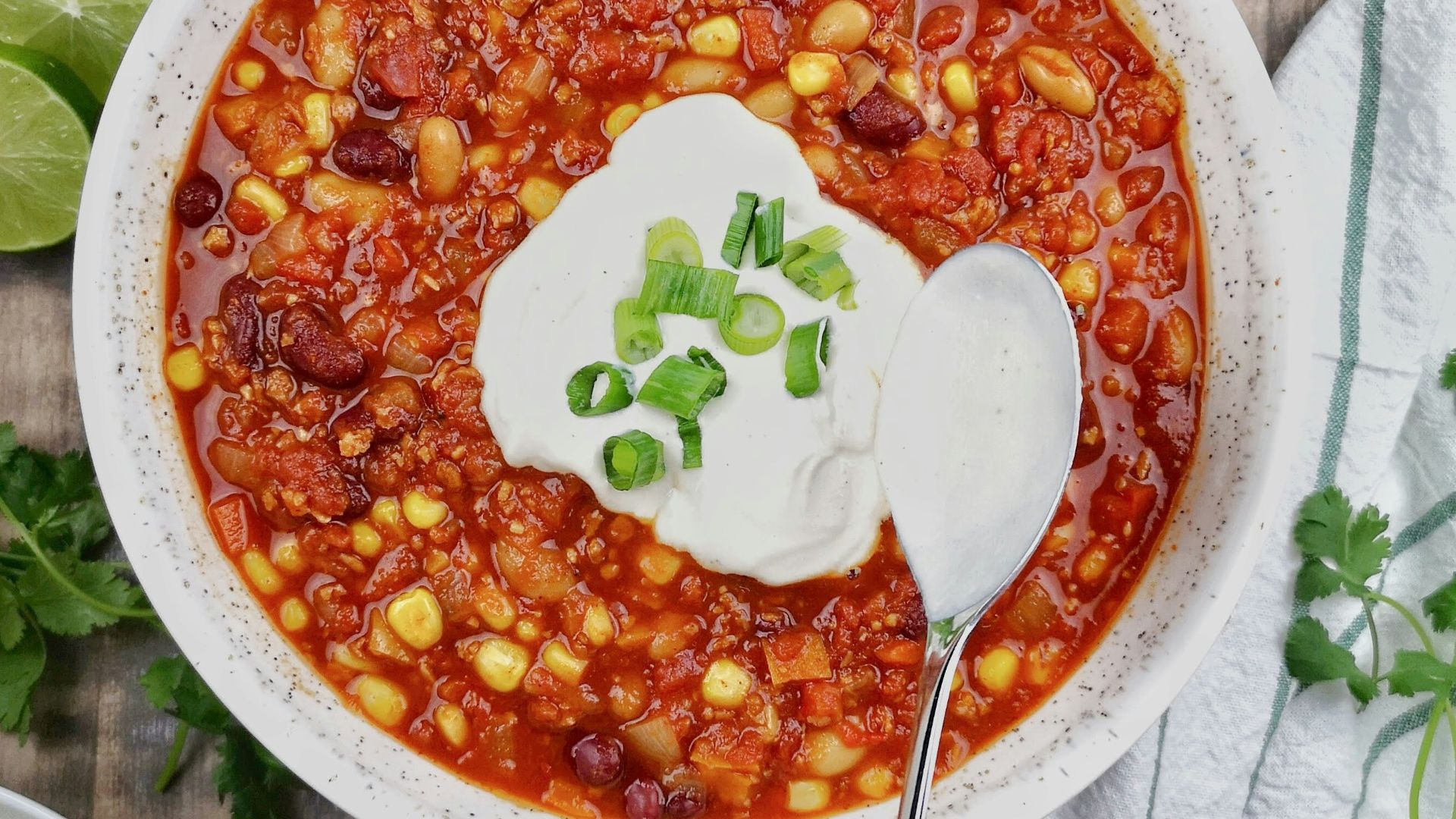 a bowl of chili with sour cream on top