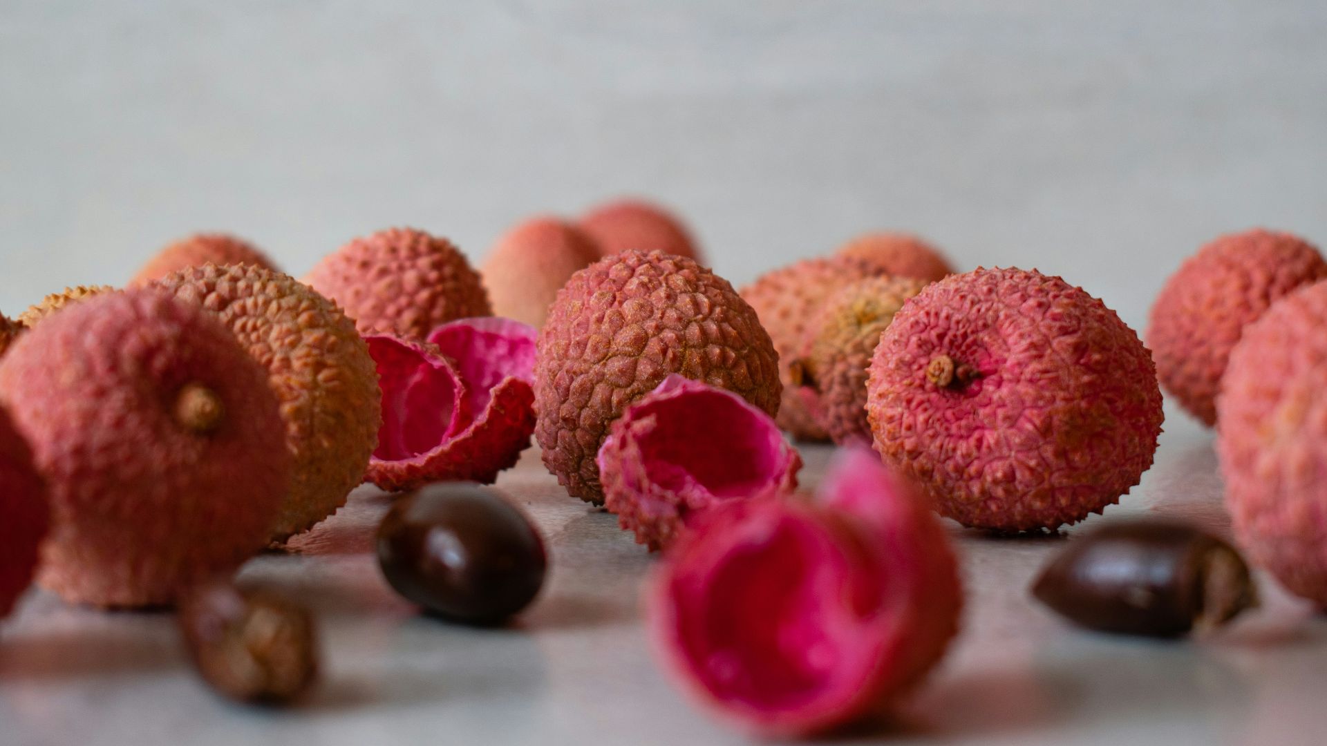 brown and pink round fruit on white table