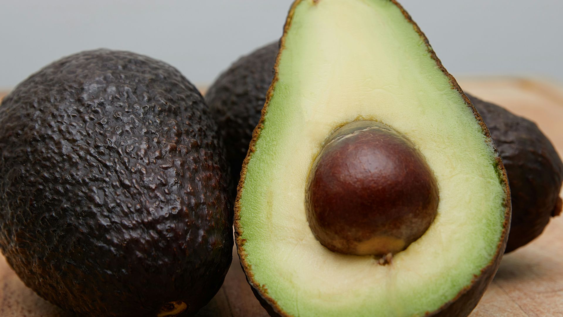 sliced avocado fruit on brown wooden table