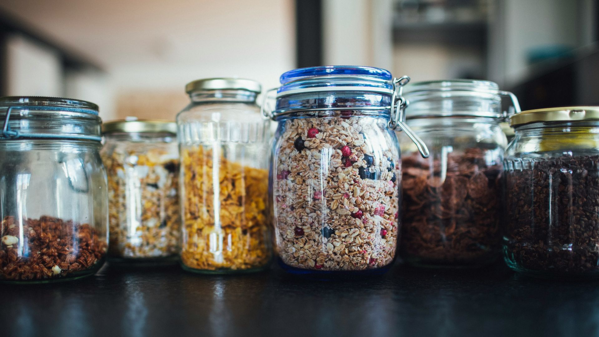 brown and white beans in clear glass jar