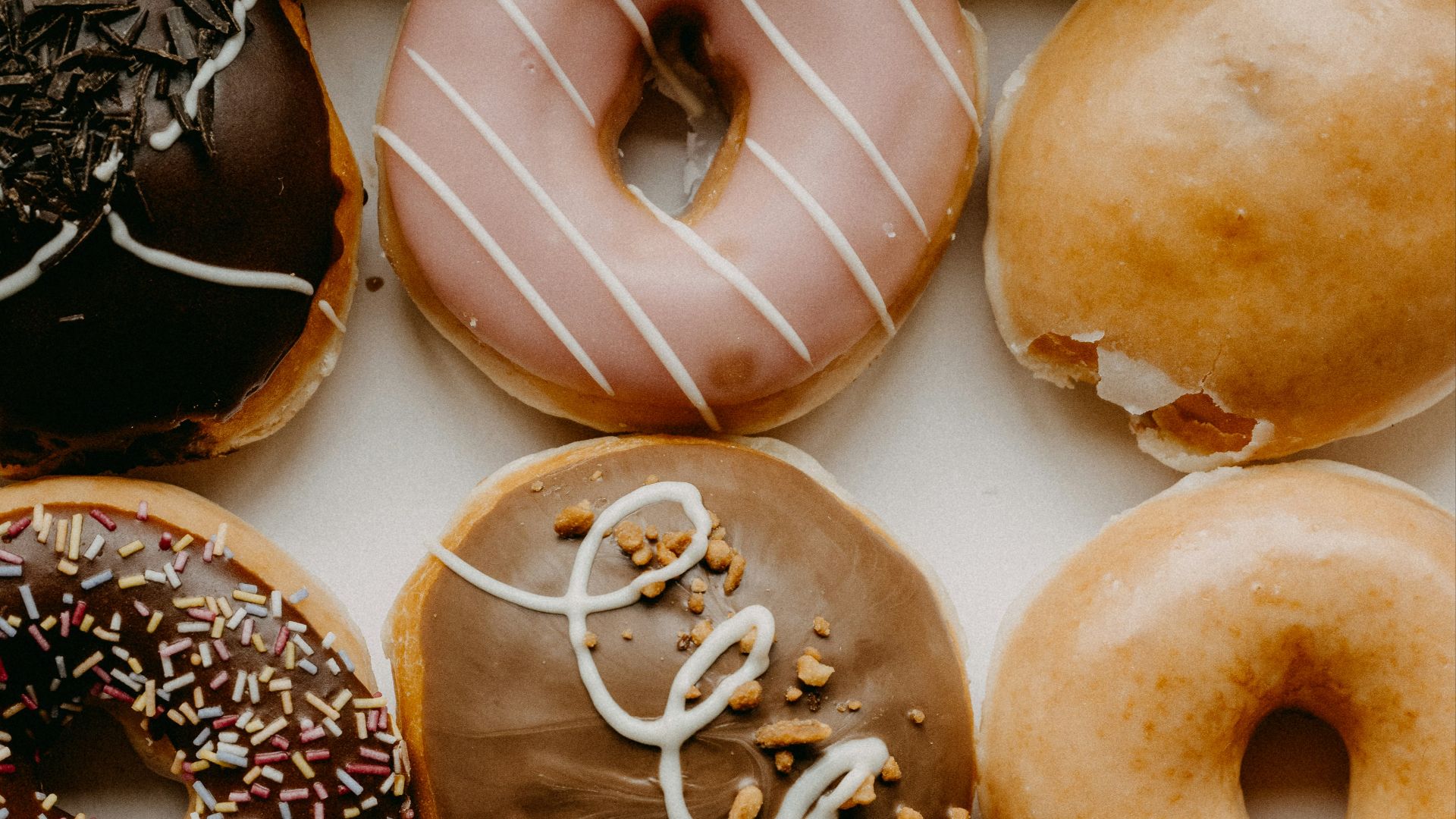 brown and white doughnuts on white ceramic plate