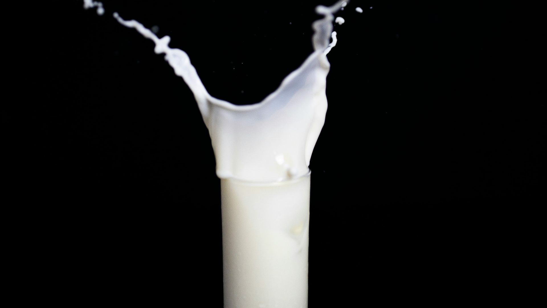 white candle in black holder