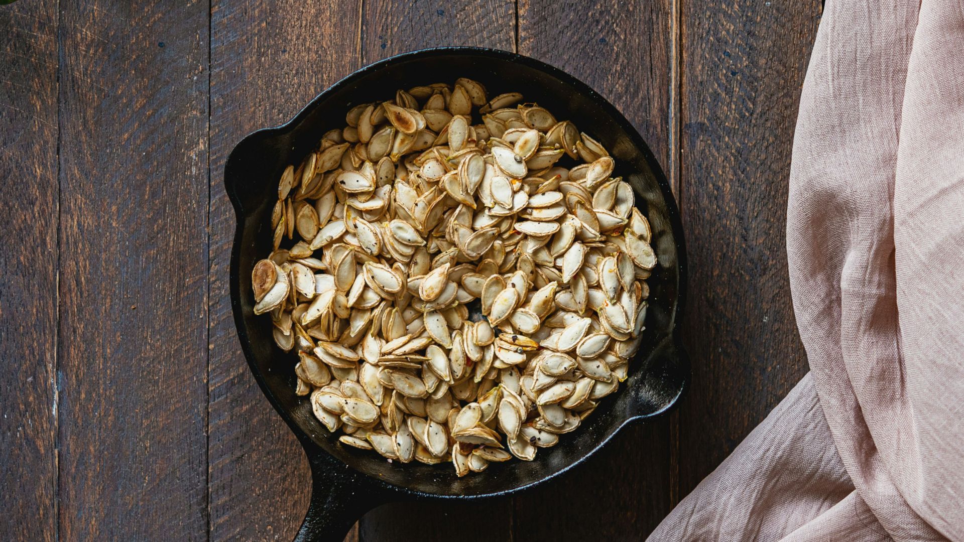 black cast iron pan with brown wooden handle