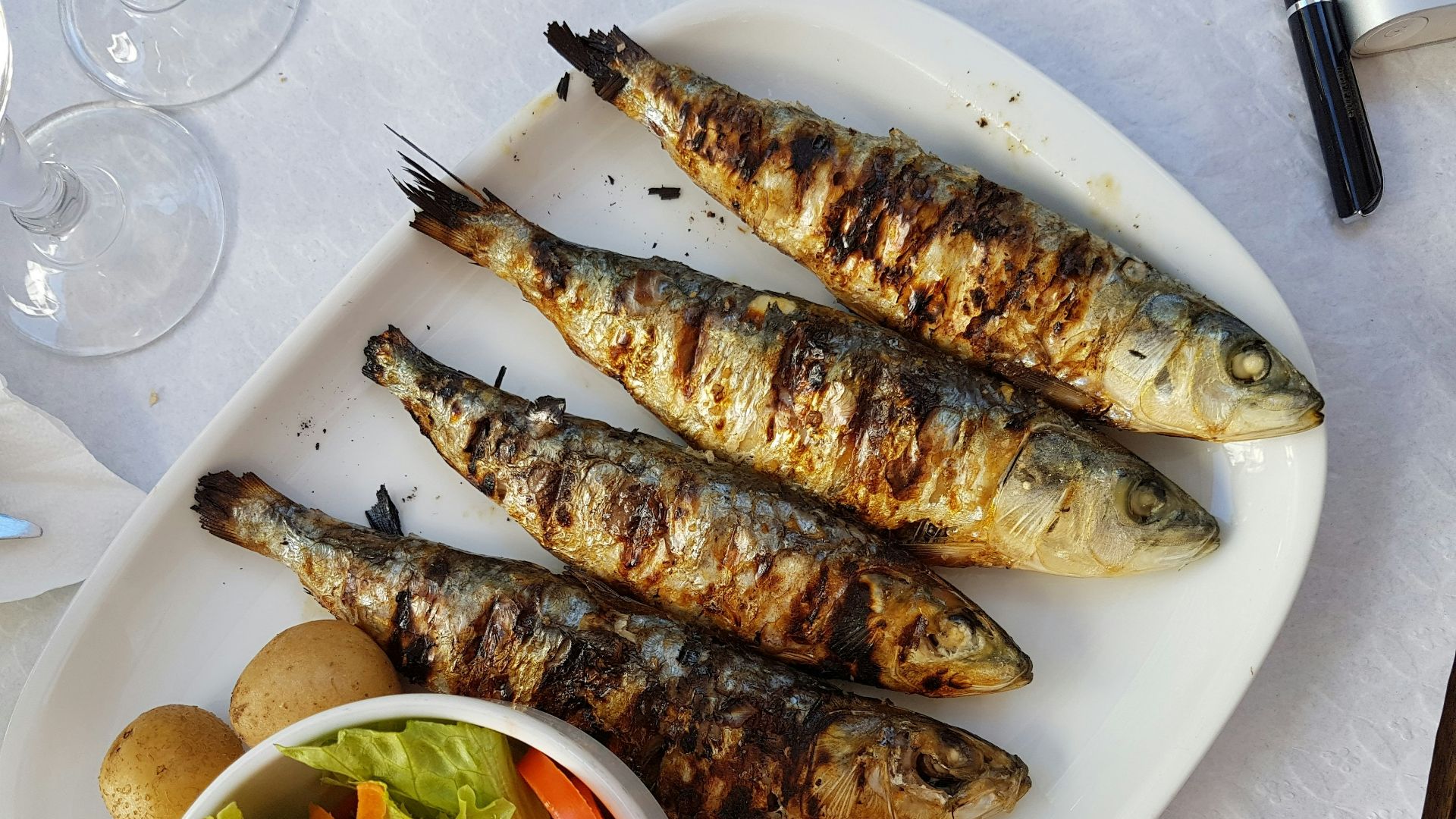 grilled fish with vegetable salad on white ceramic plate