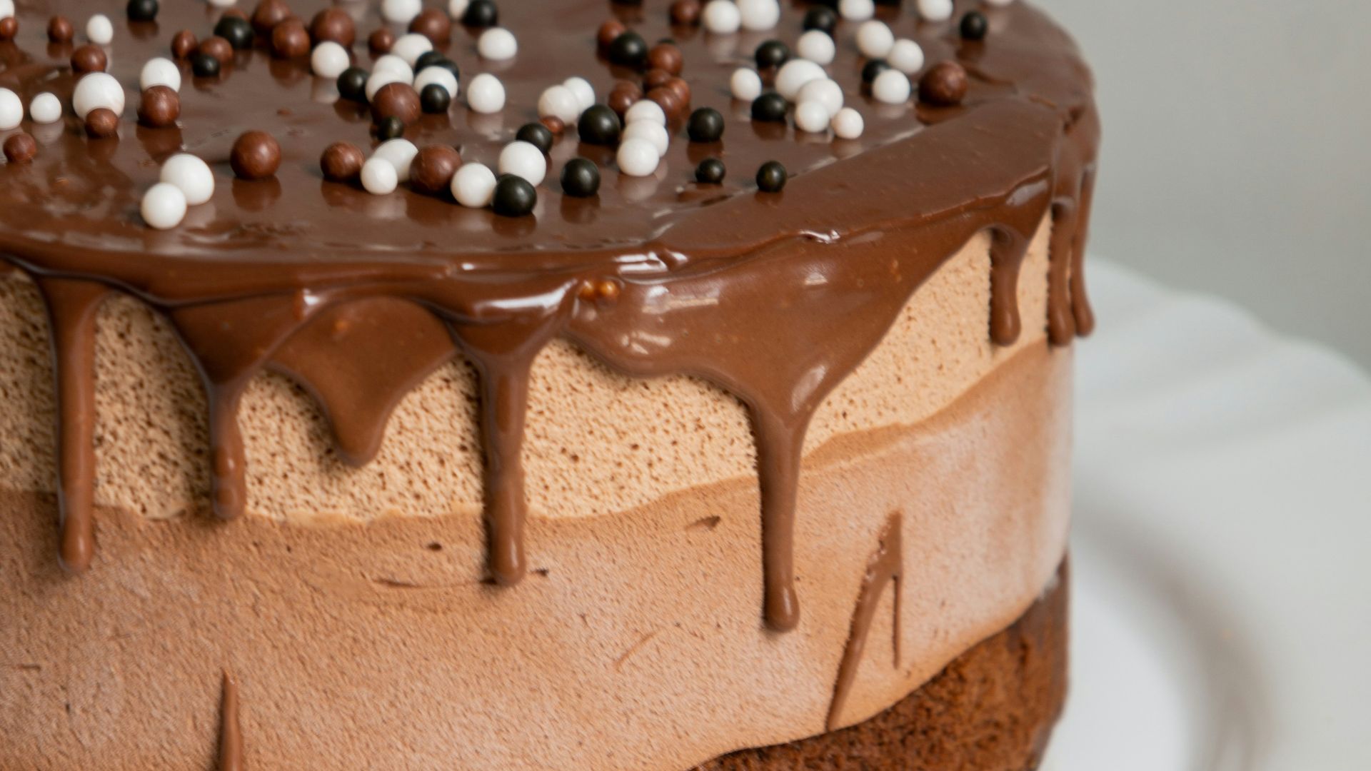 chocolate cake with white icing on white ceramic plate