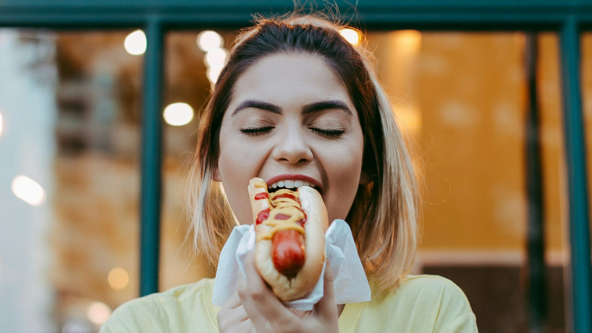 woman in white crew neck t-shirt eating apple