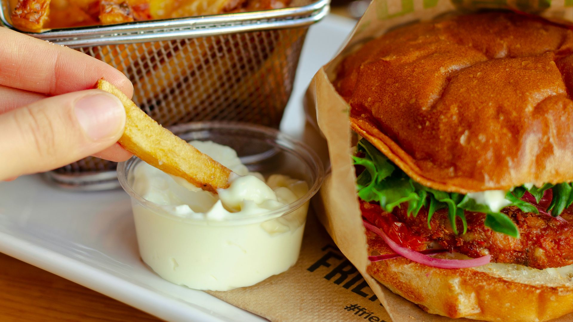 burger with cheese and vegetable on stainless steel tray