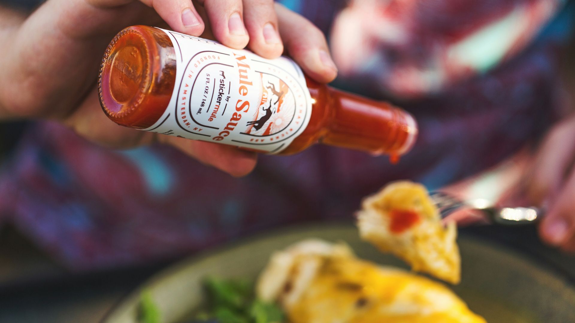 person holding white labeled bottle