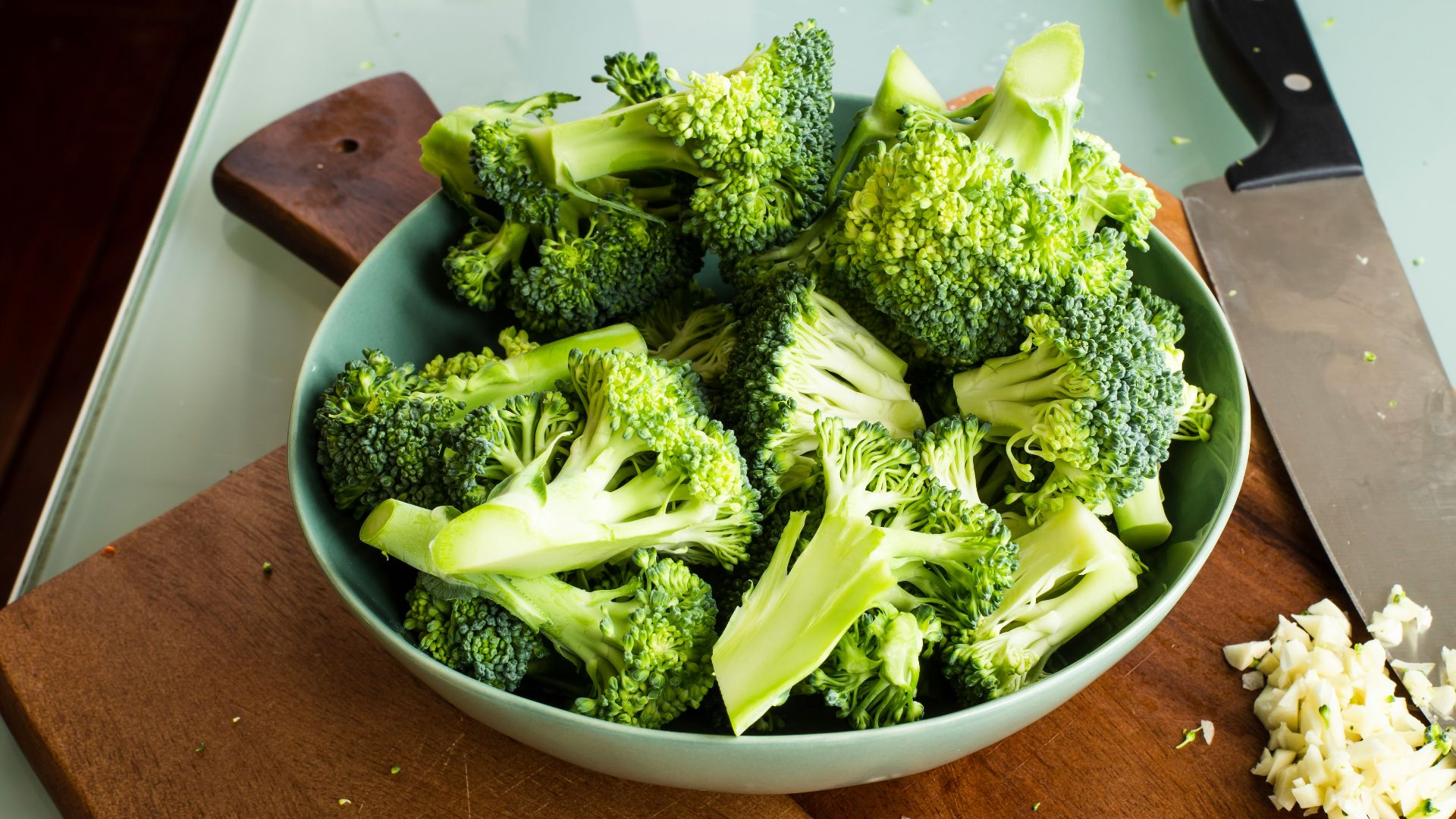 green broccoli on brown wooden chopping board