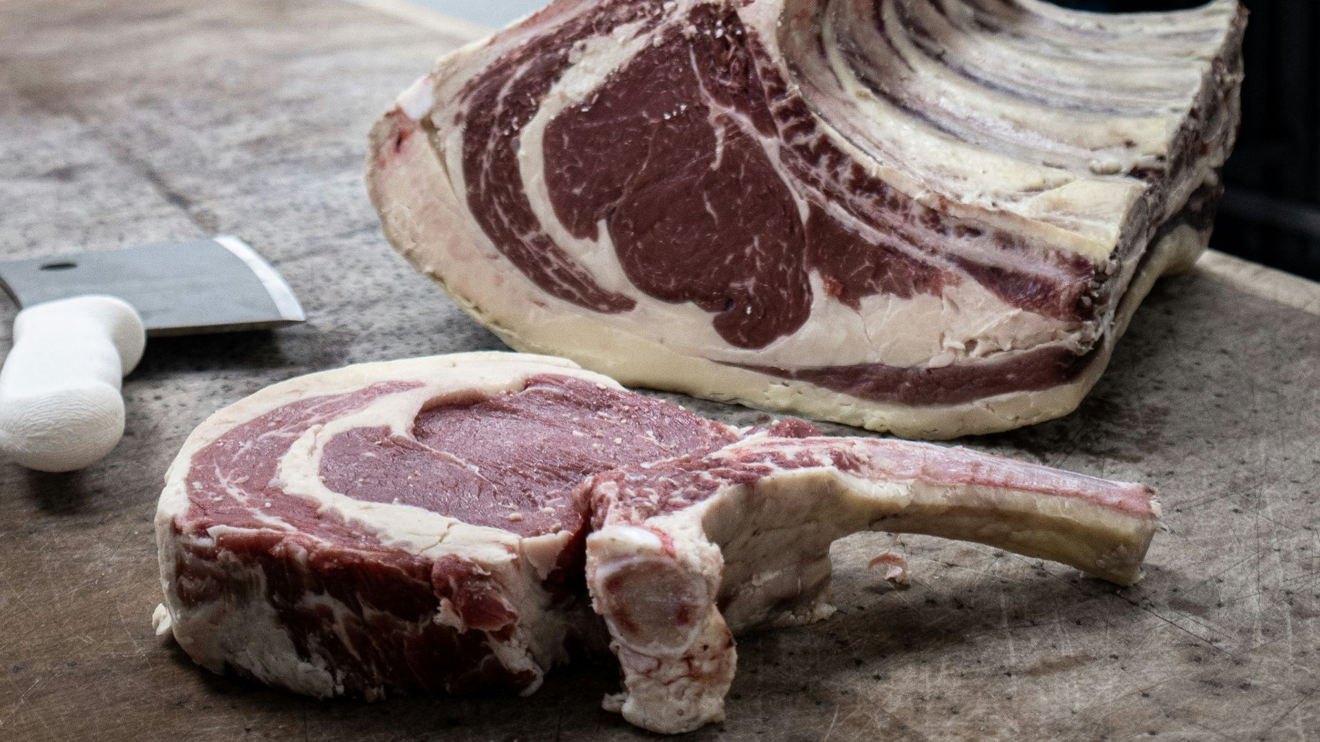 raw meat on brown wooden chopping board