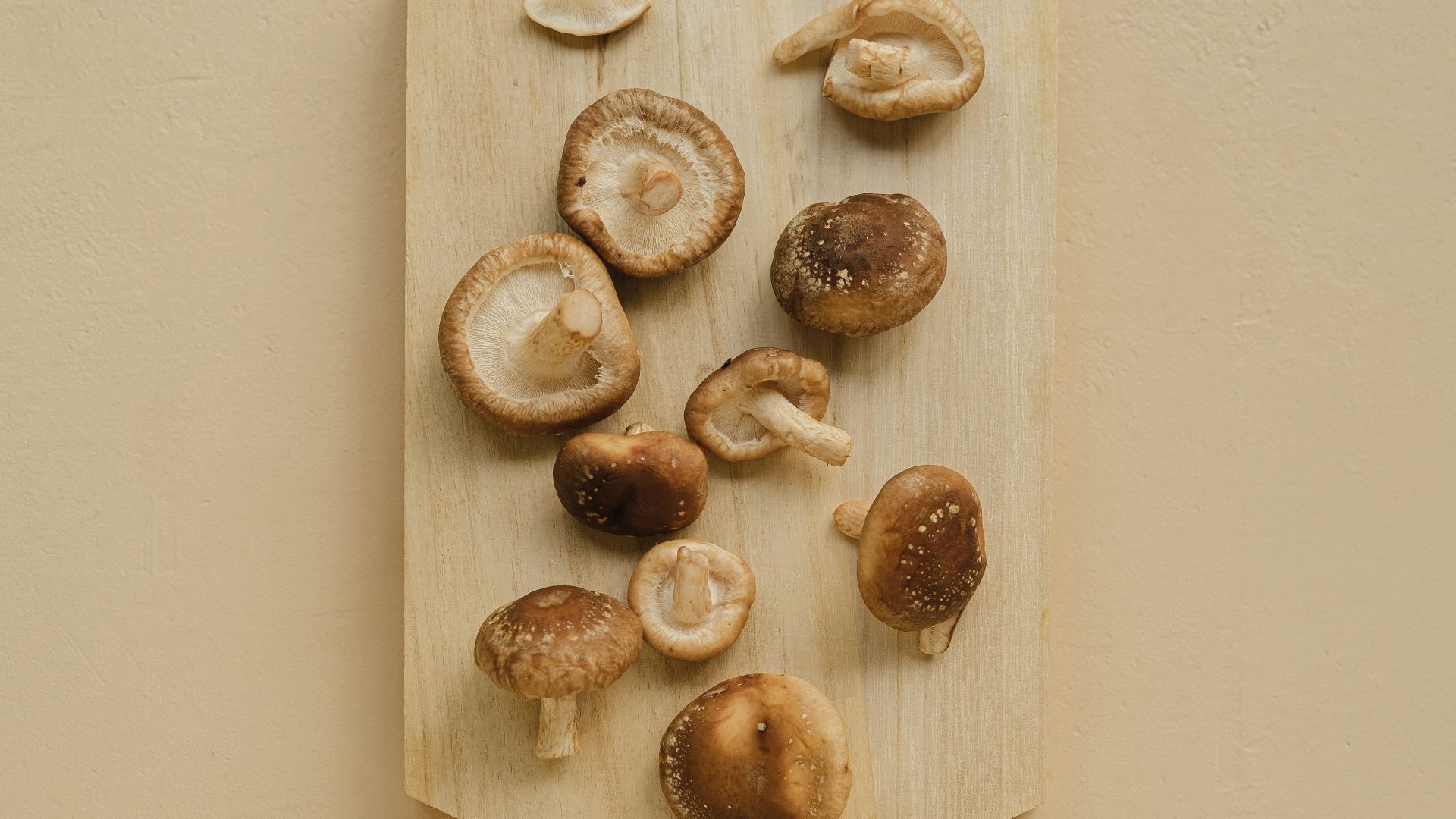 A cutting board with a bunch of mushrooms on it