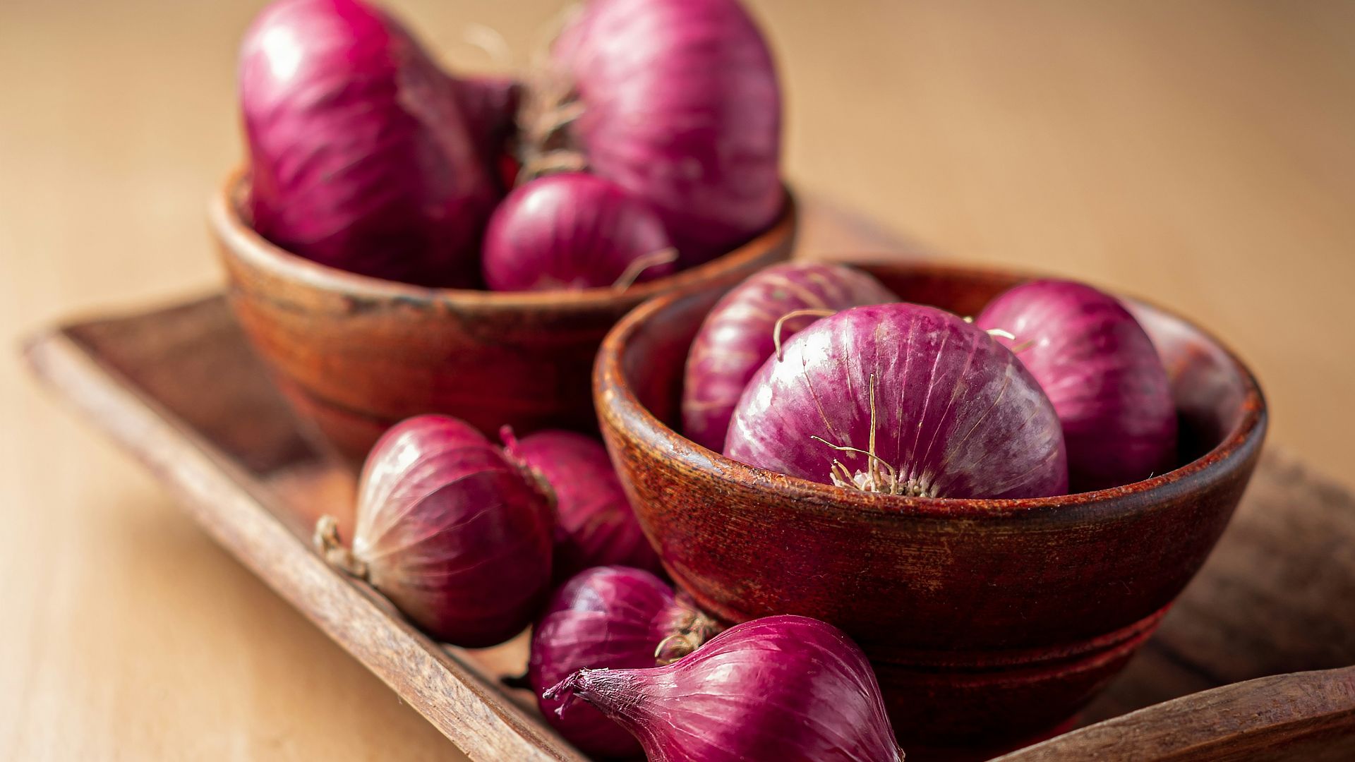 red onion on brown wooden tray