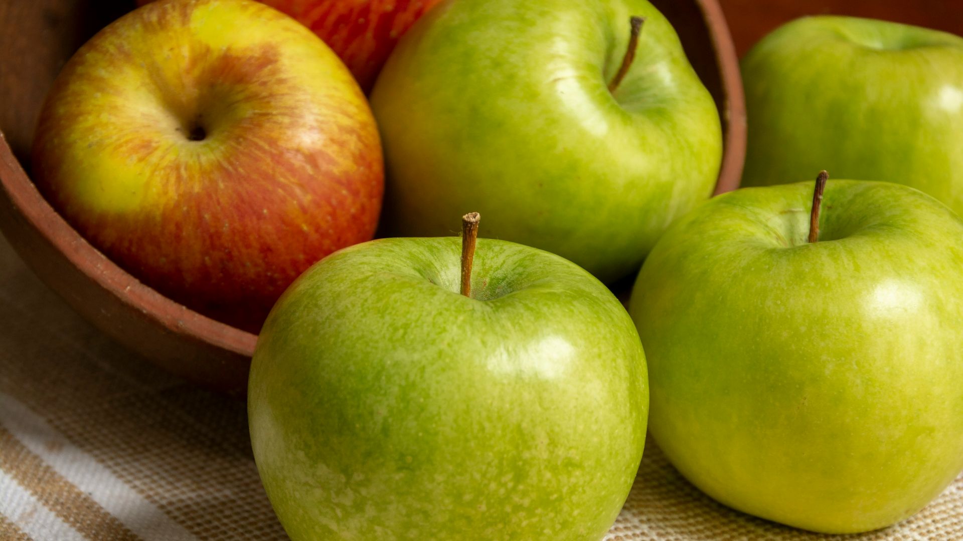 green apple on white table cloth