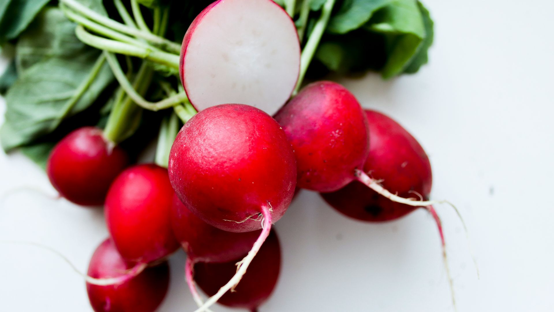red tomato on white surface