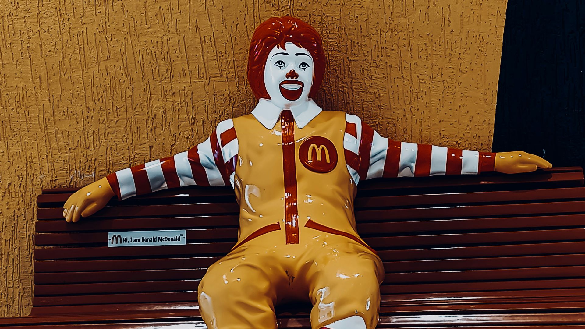 a clown sitting on a bench