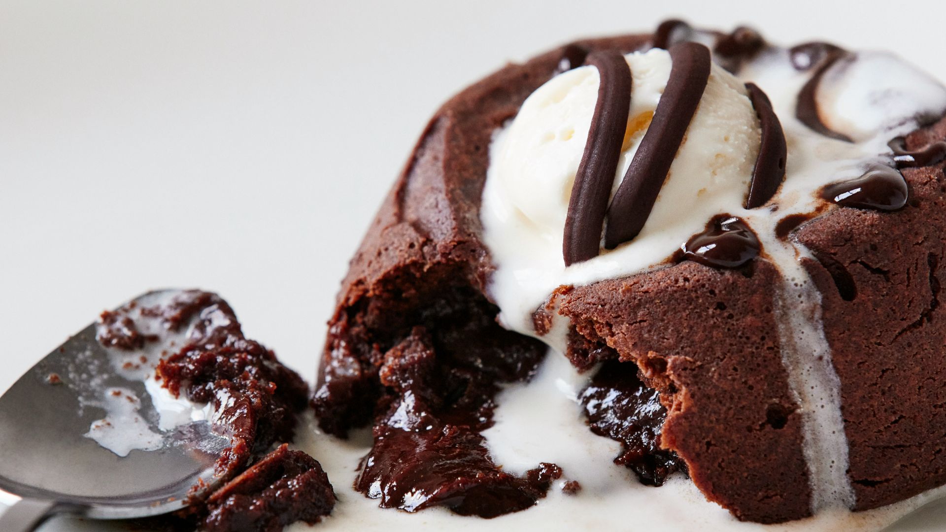 a white plate topped with a piece of cake and ice cream