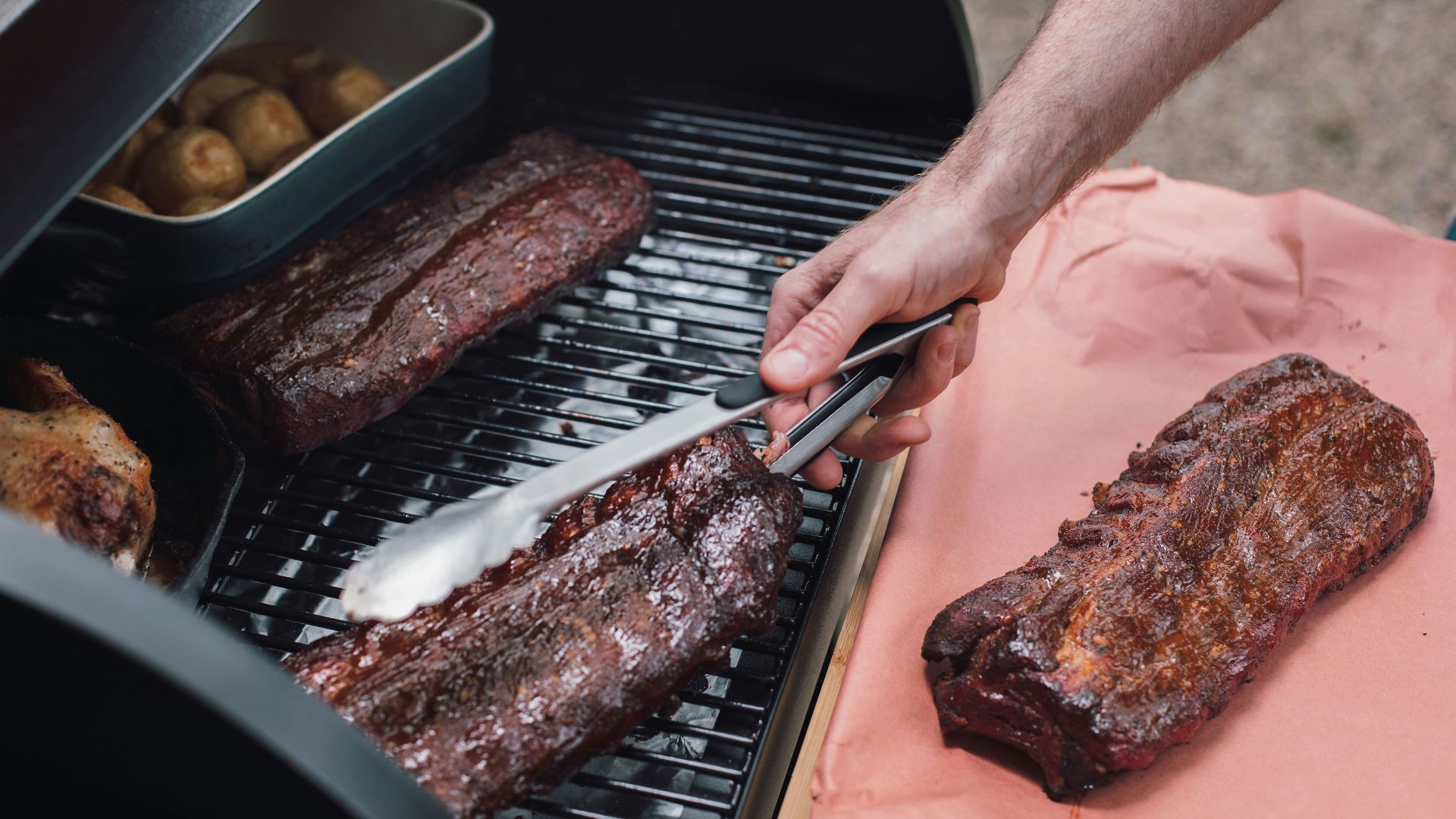 person slicing meat on tray