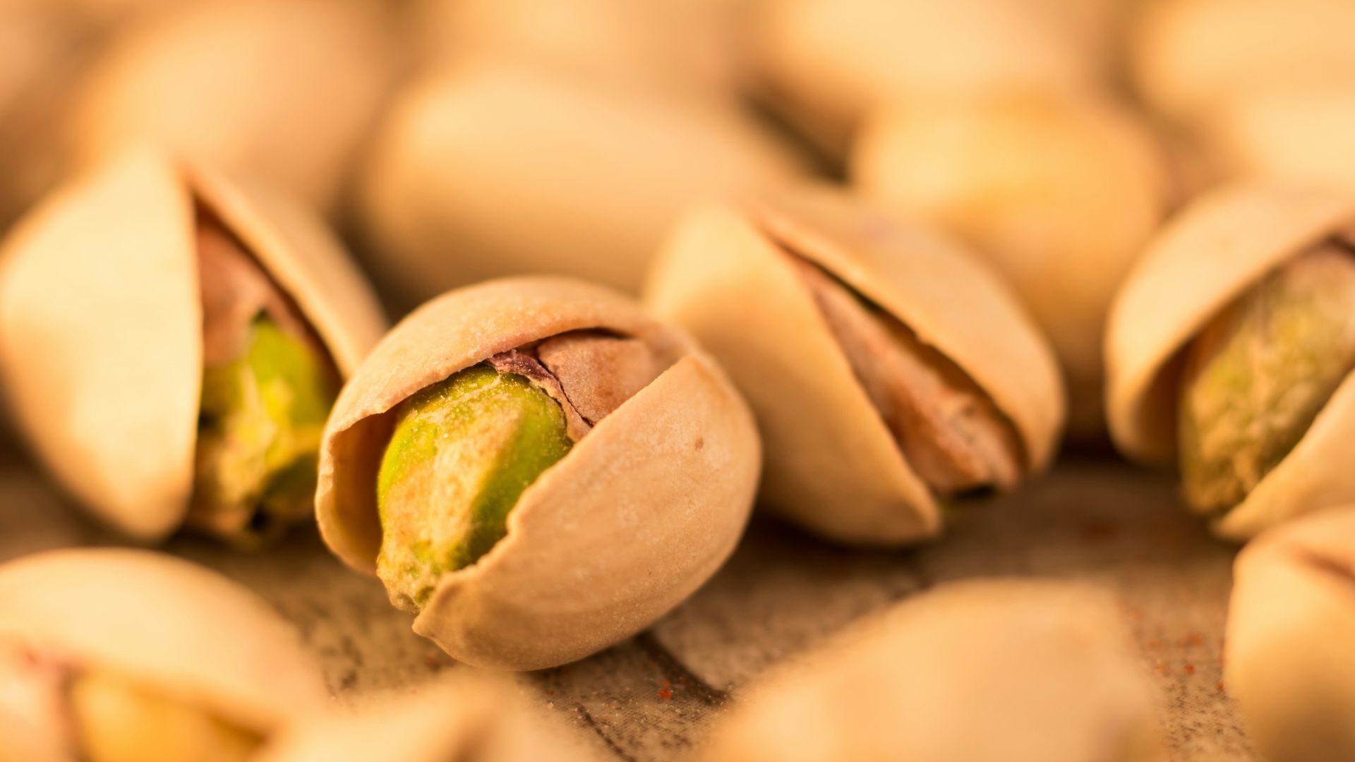 a pile of pistachio nuts sitting on top of a table
