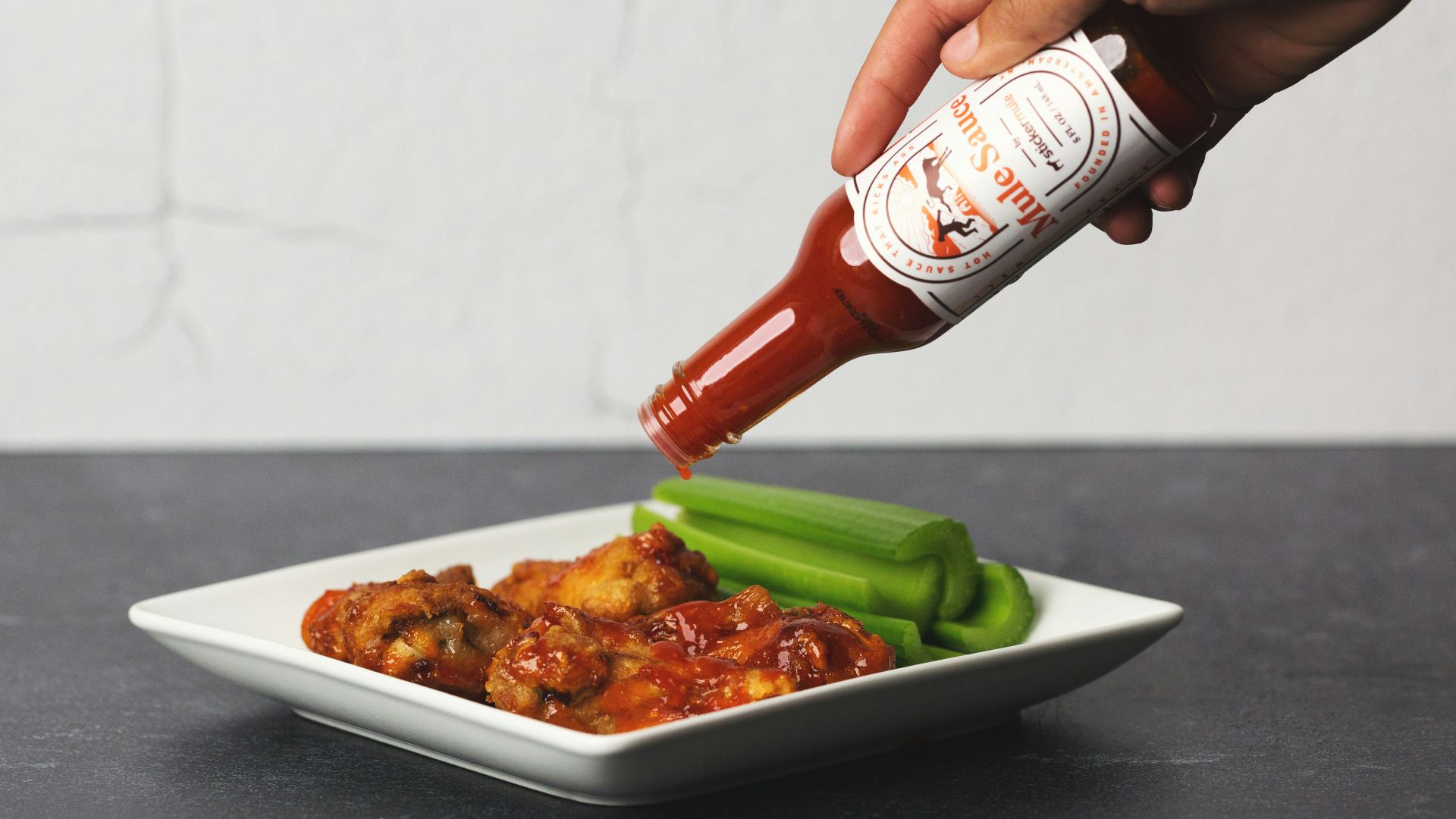 person holding white ceramic plate with food