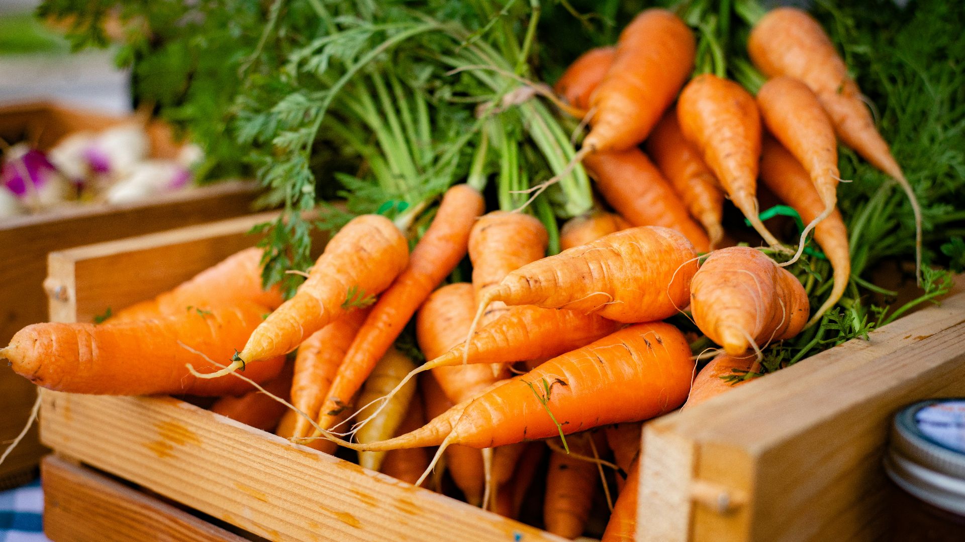 orange carrots on brown wooden crate