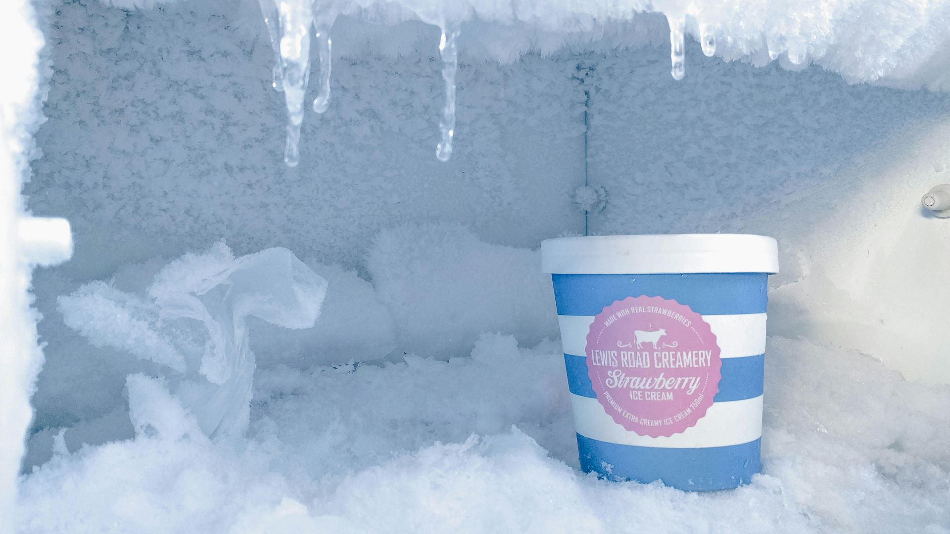 strawberry ice cream bottle inside container covered in ice