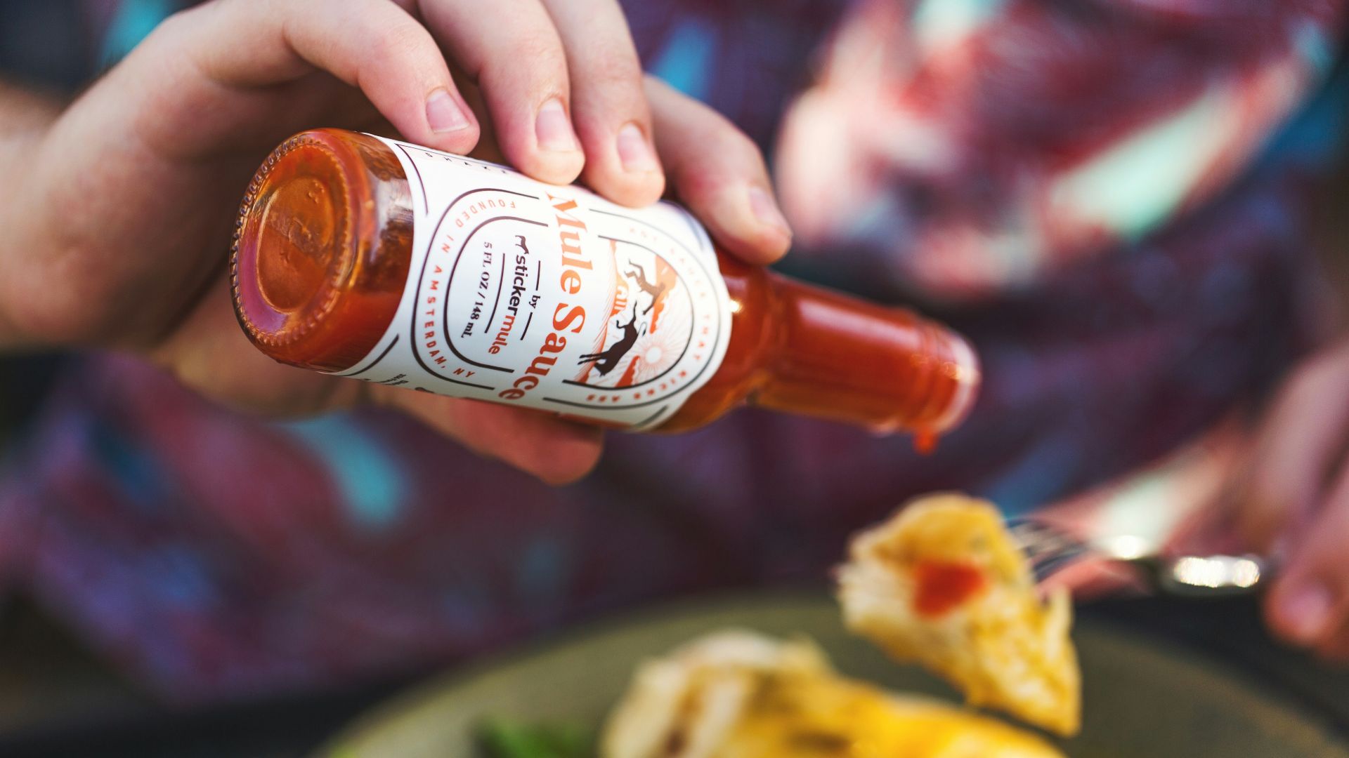 person holding white labeled bottle