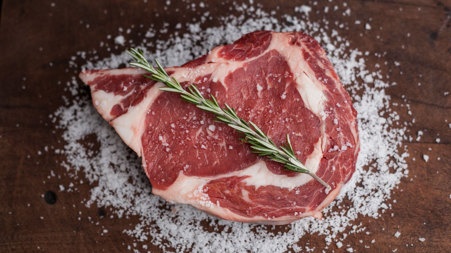 raw meat on brown wooden table