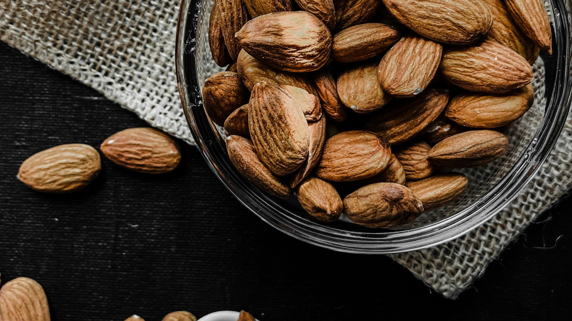 brown almond nuts on stainless steel bowl