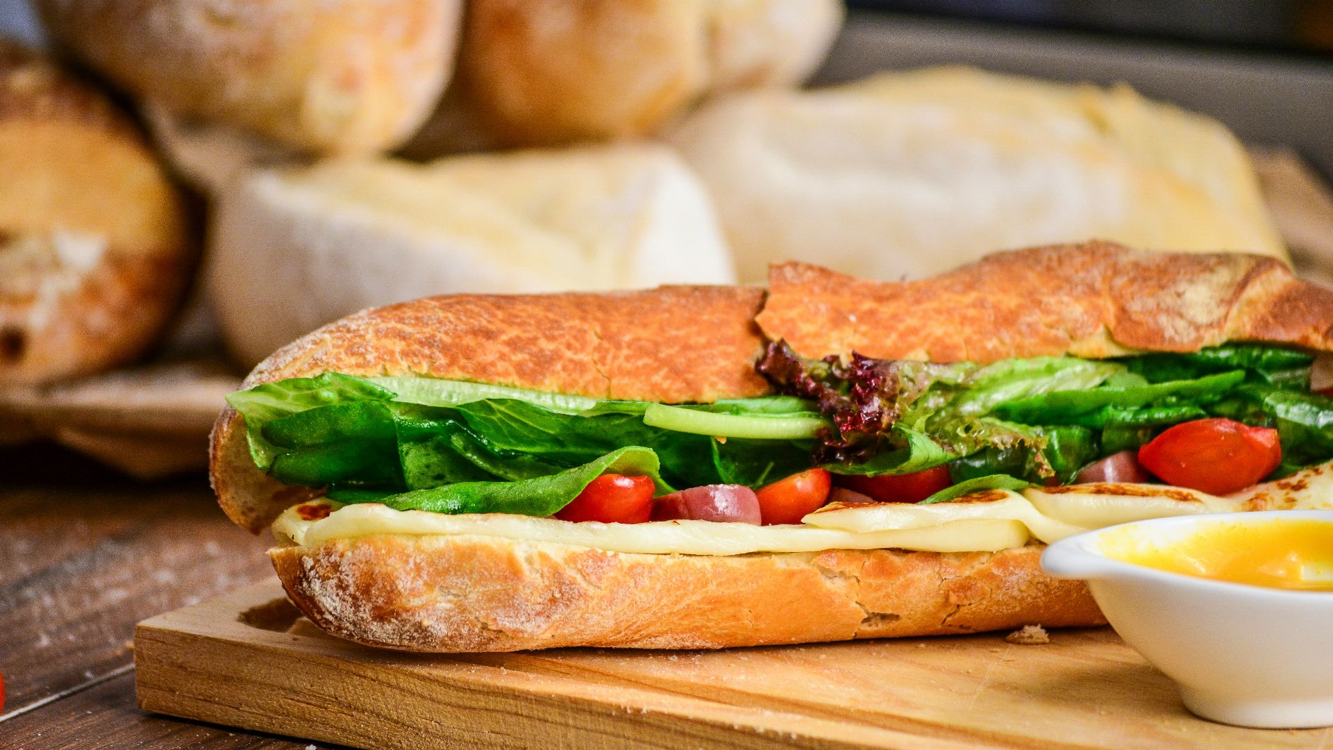 baked bread with vegetable on brown chopping board