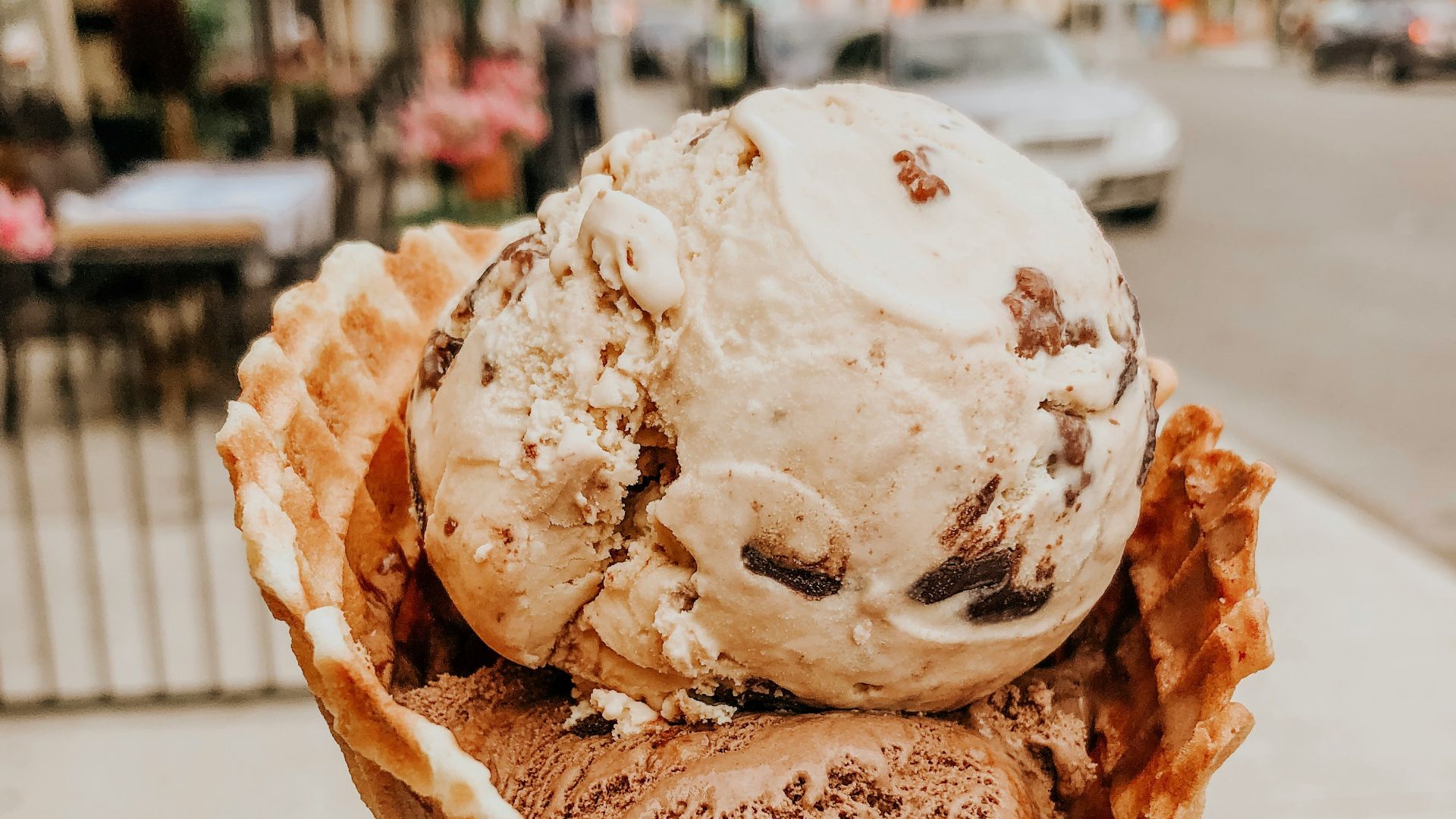 person holding ice cream in cone