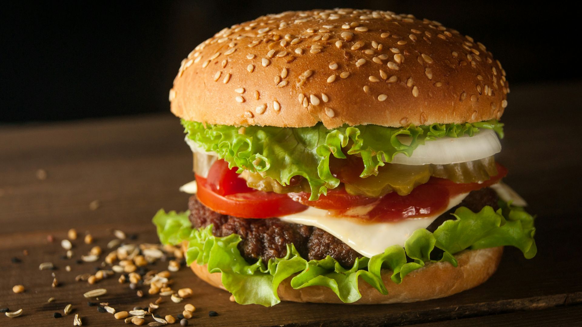 meat and cheese burger surrounded by sesame seeds