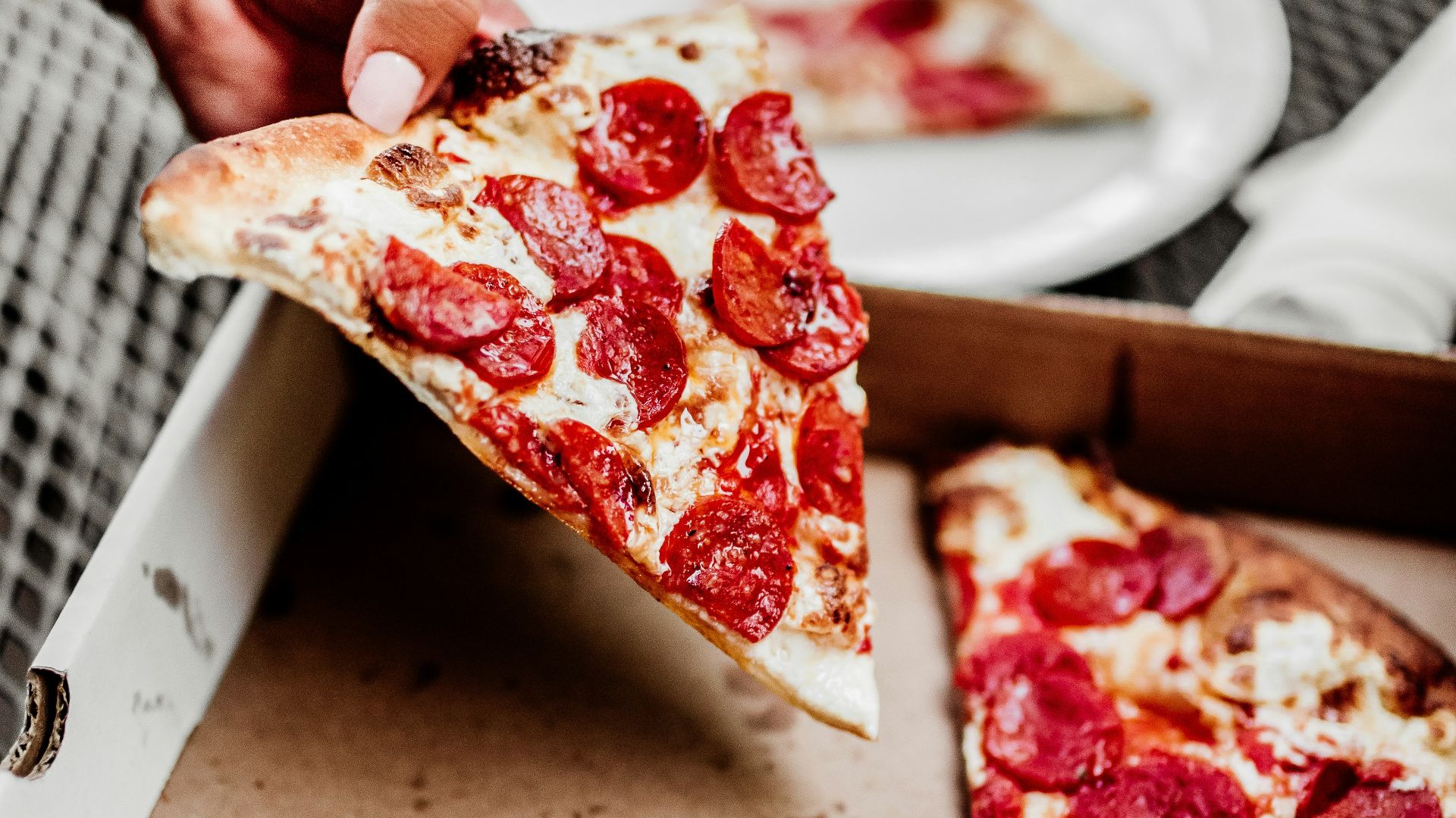 sliced pizza on white ceramic plate