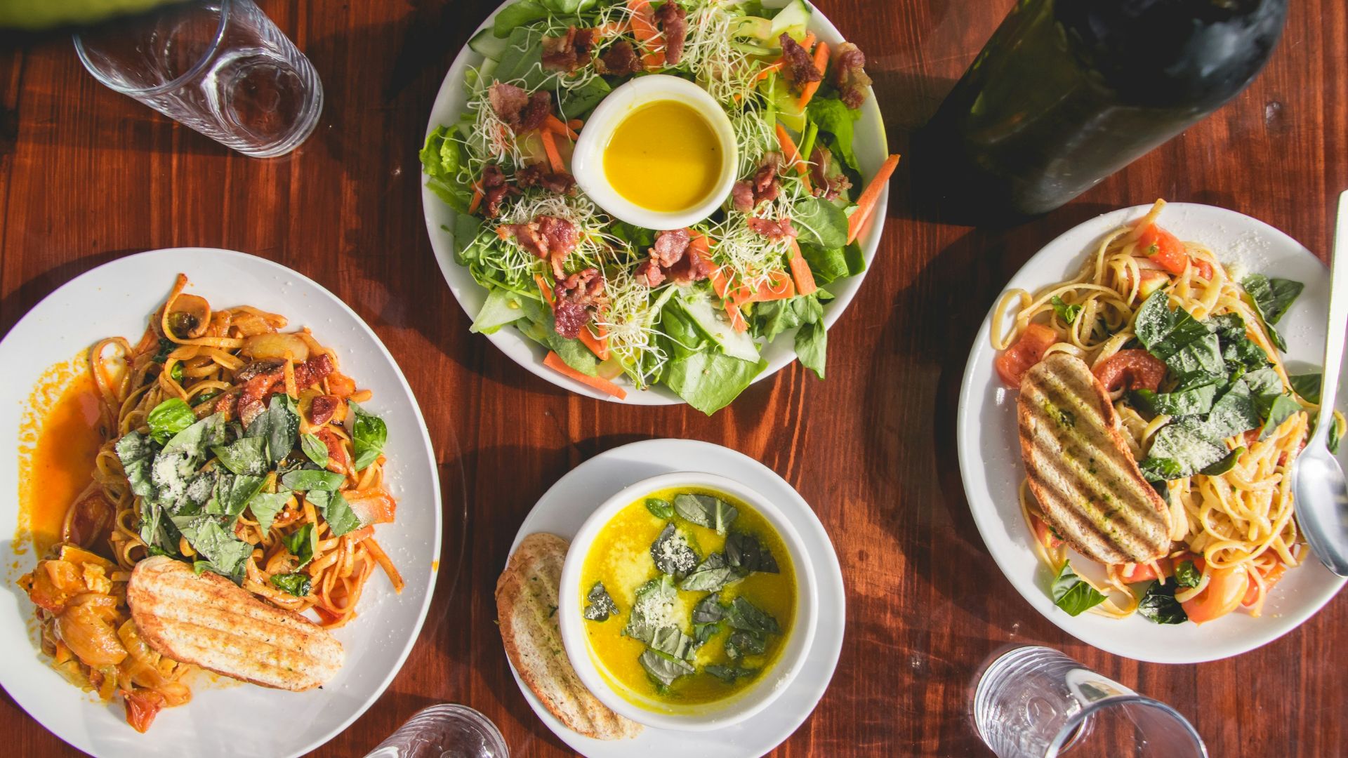 four assorted dishes on wooden surface