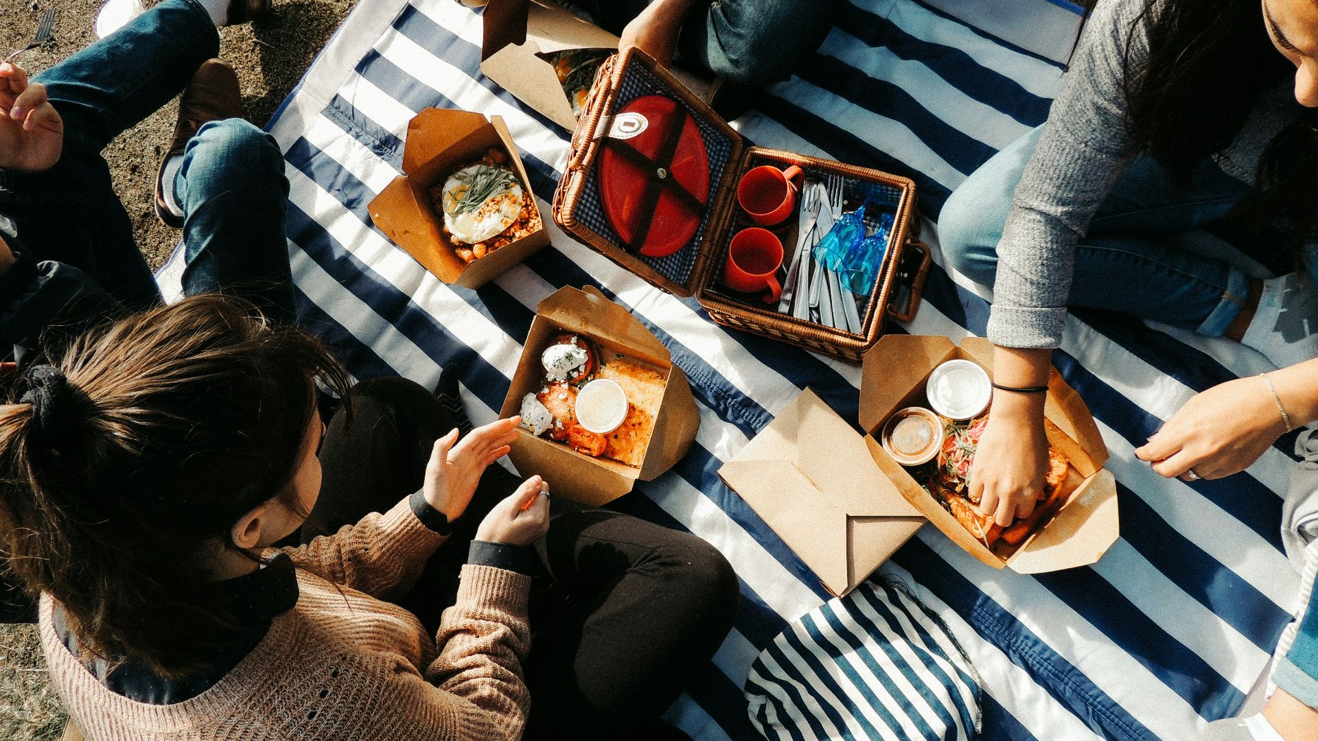 woman in gray sweater sitting beside man in black and white stripe shirt