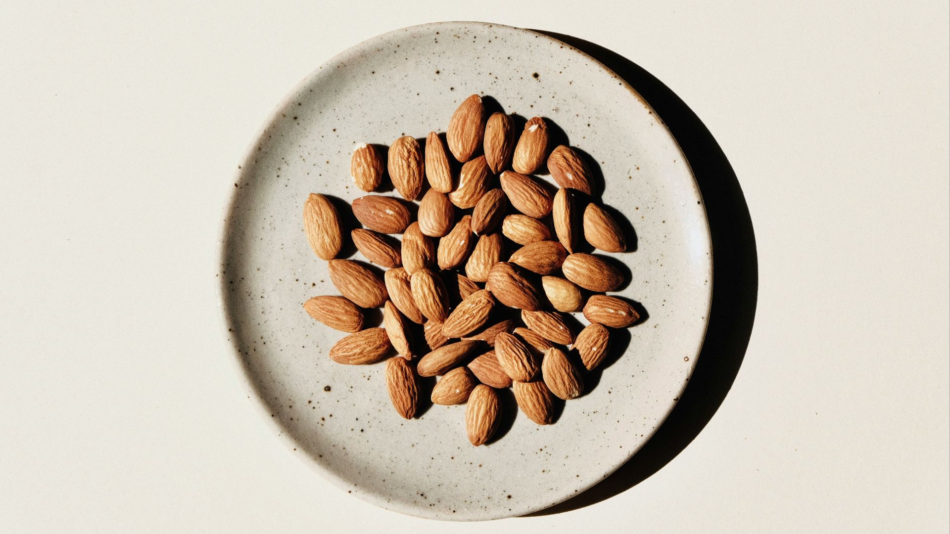 brown coffee beans on white ceramic bowl