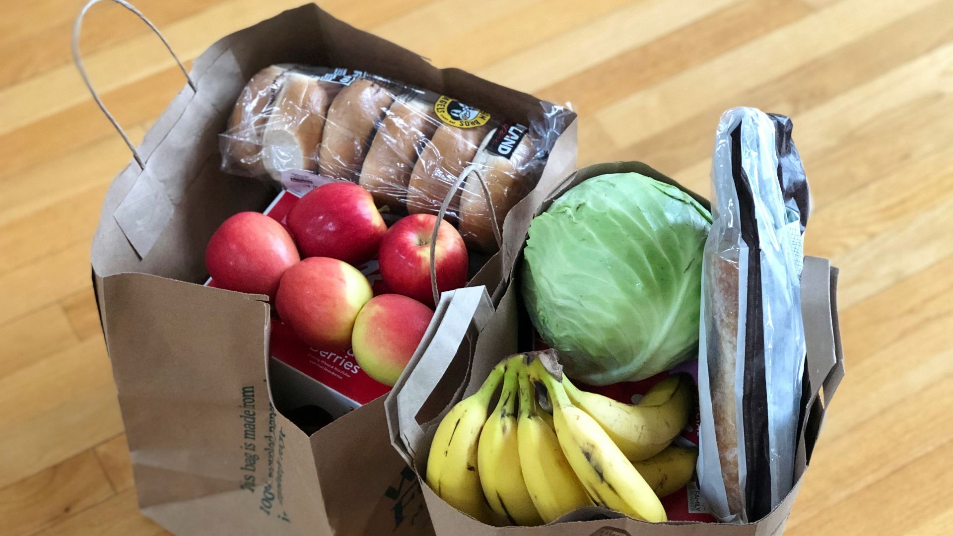 apples and bananas in brown cardboard box