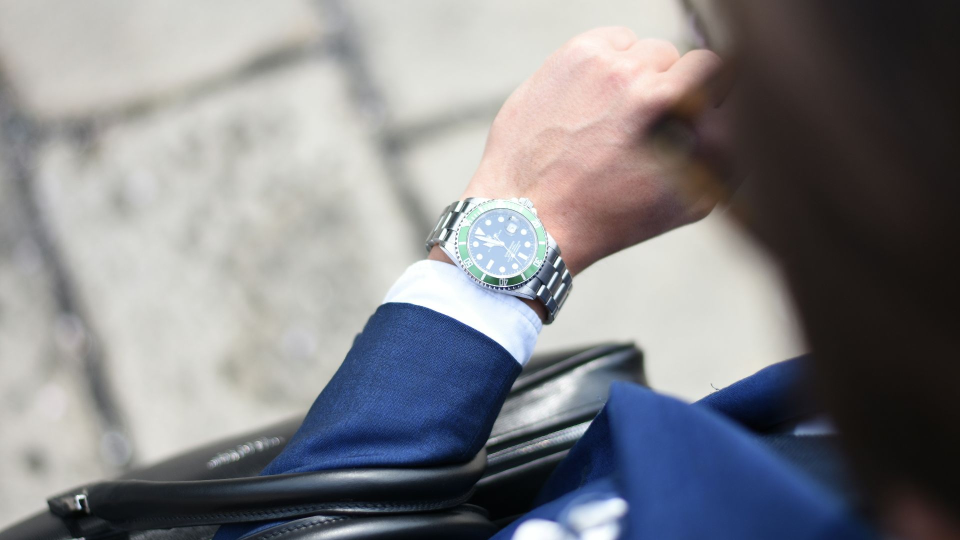 person looking at silver-colored analog watch