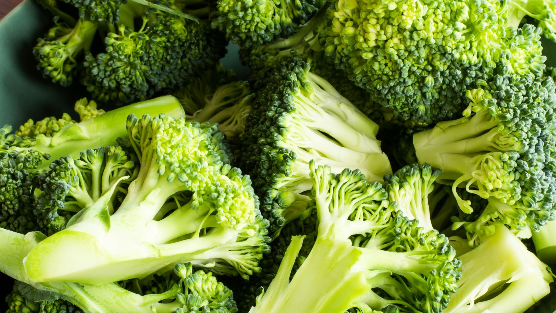 green broccoli on brown wooden chopping board