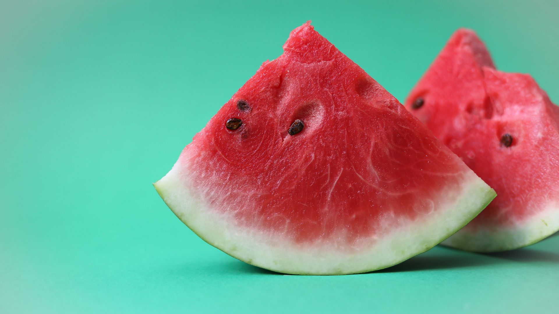 sliced watermelon on green surface