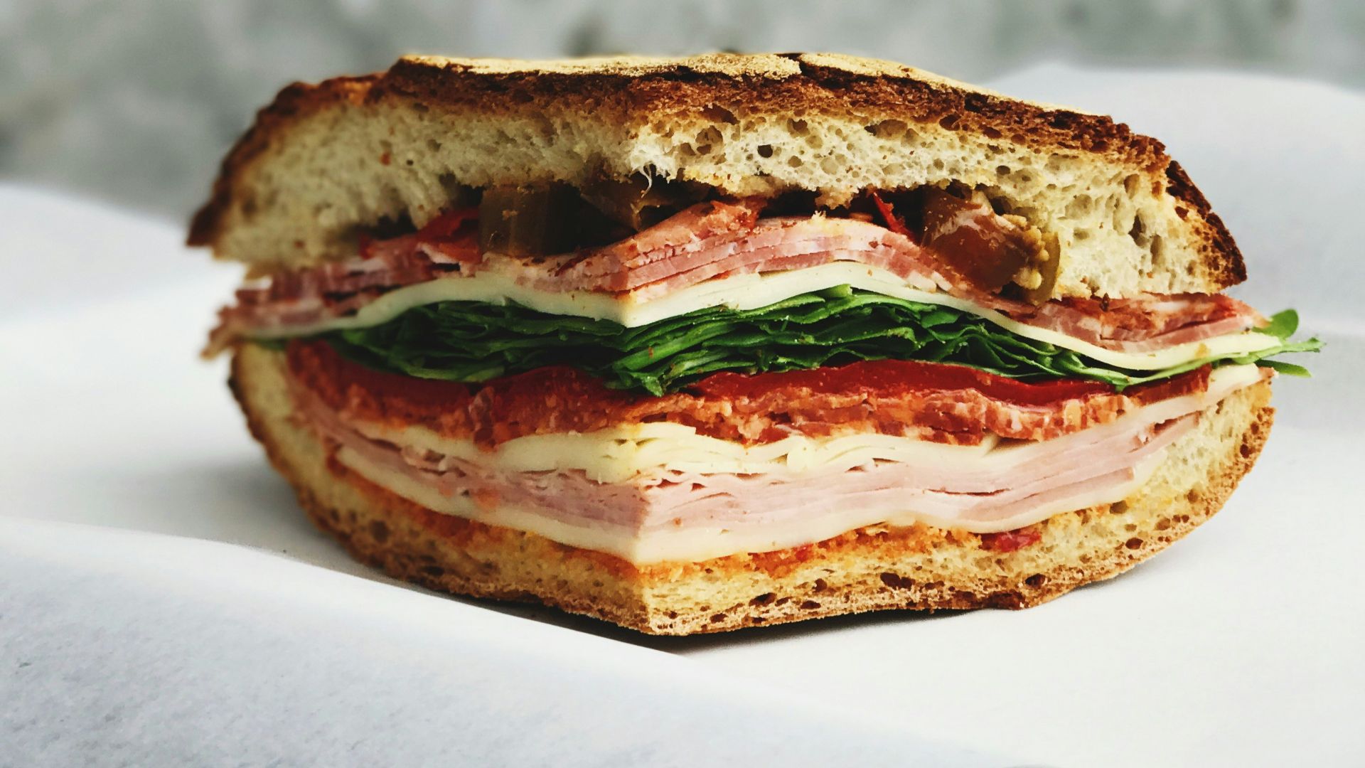 ham sandwich on white surface