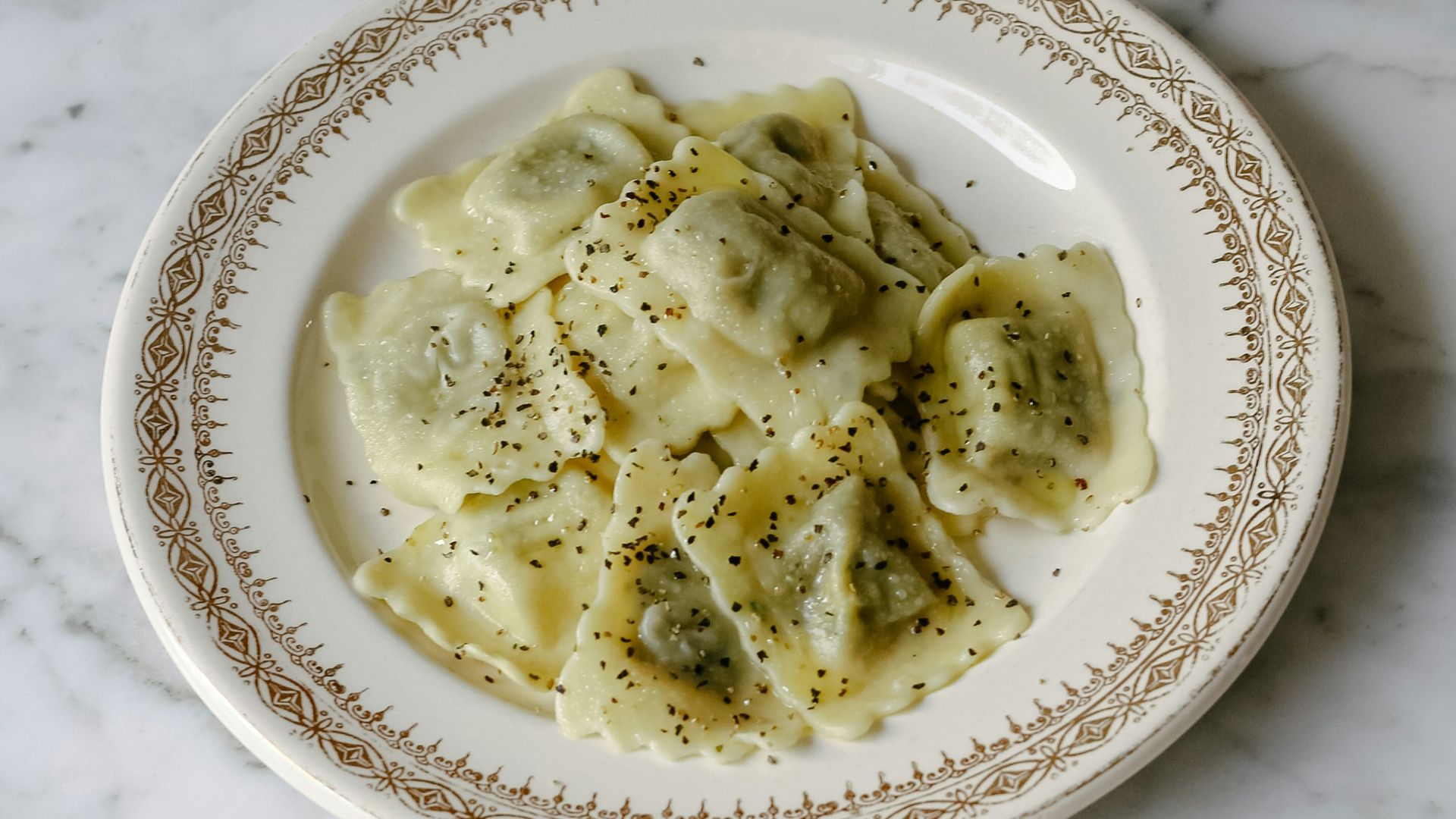 Plate of ravioli on a marble table