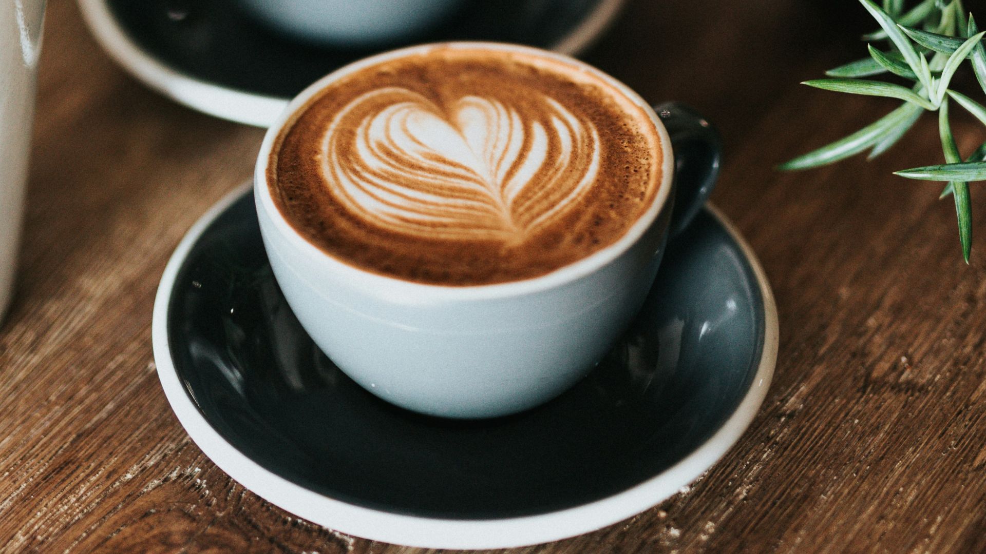 shallow focus photography of coffee late in mug on table