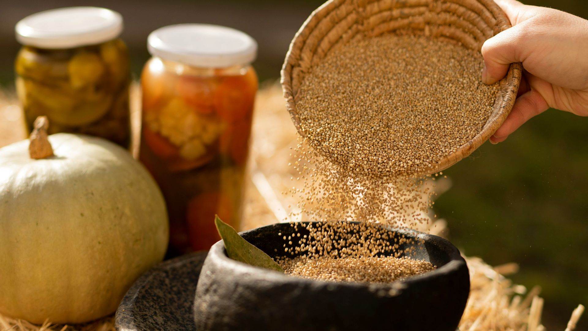 a hand holding a jar of food