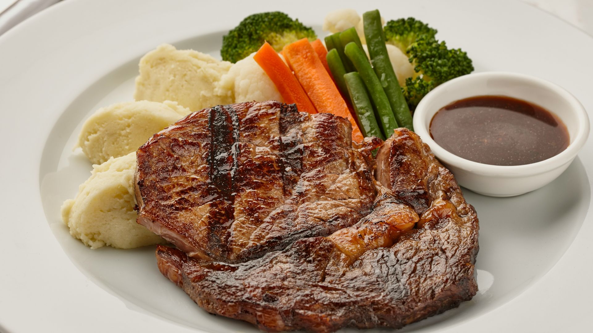 a white plate topped with meat and veggies