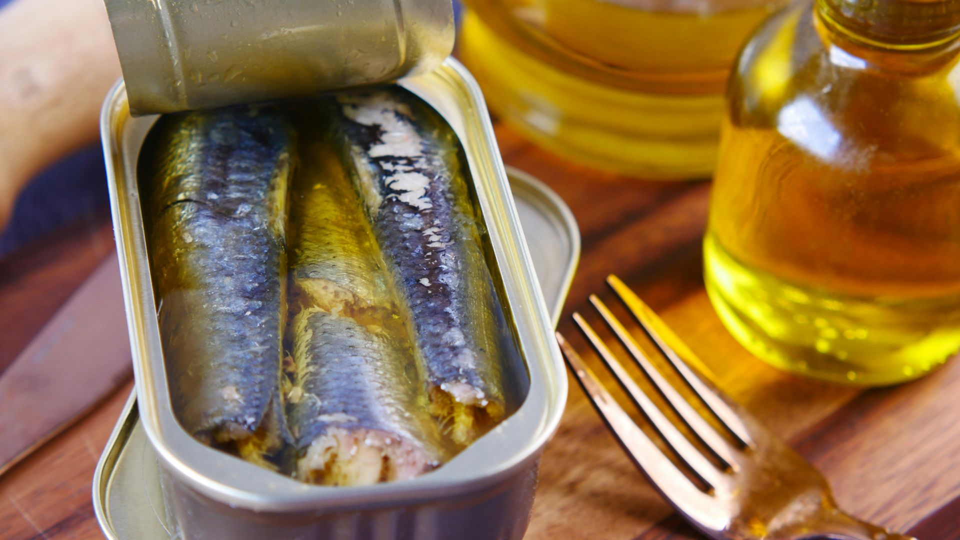 a tin of sardines sitting on top of a wooden table