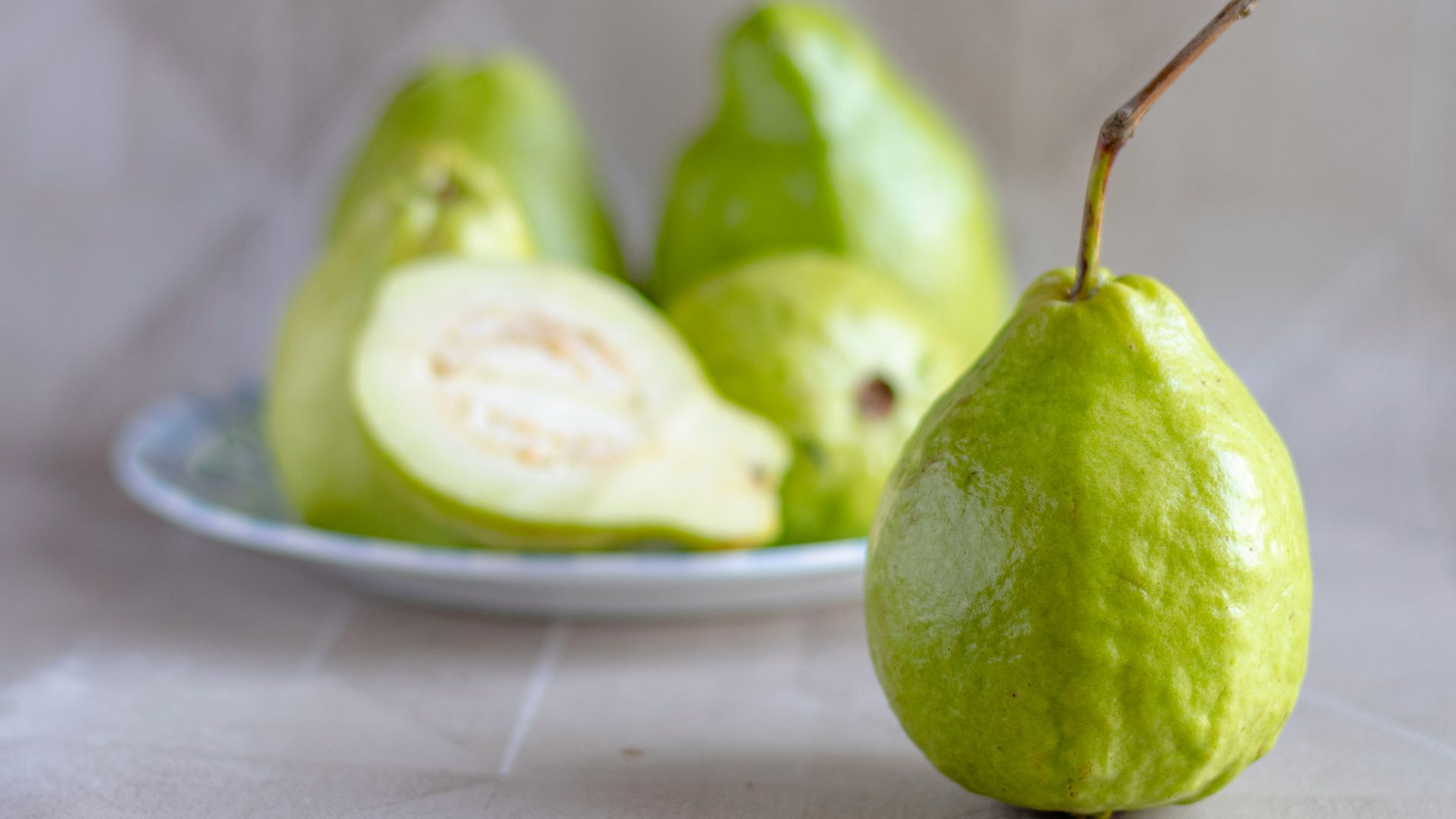 green fruit on white ceramic plate