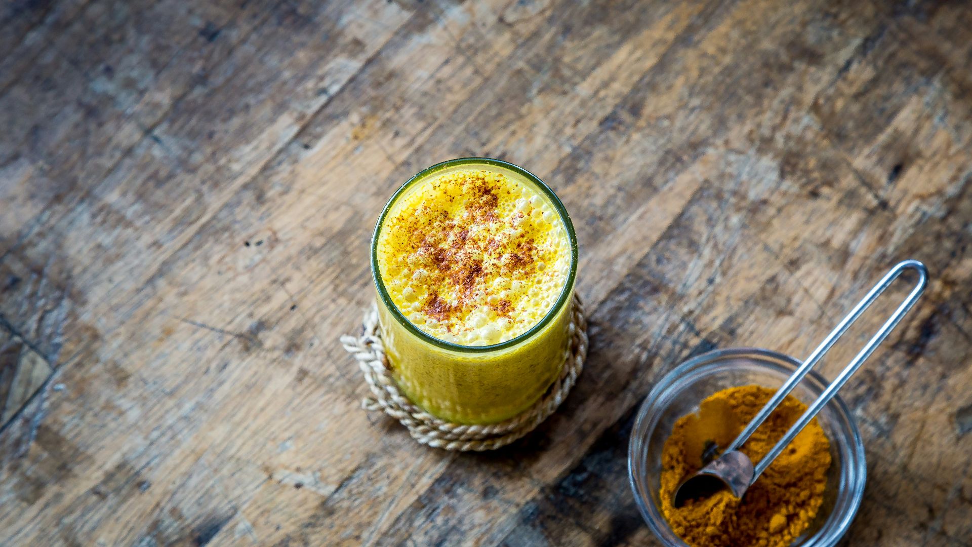 clear drinking glass full of orange liquid
