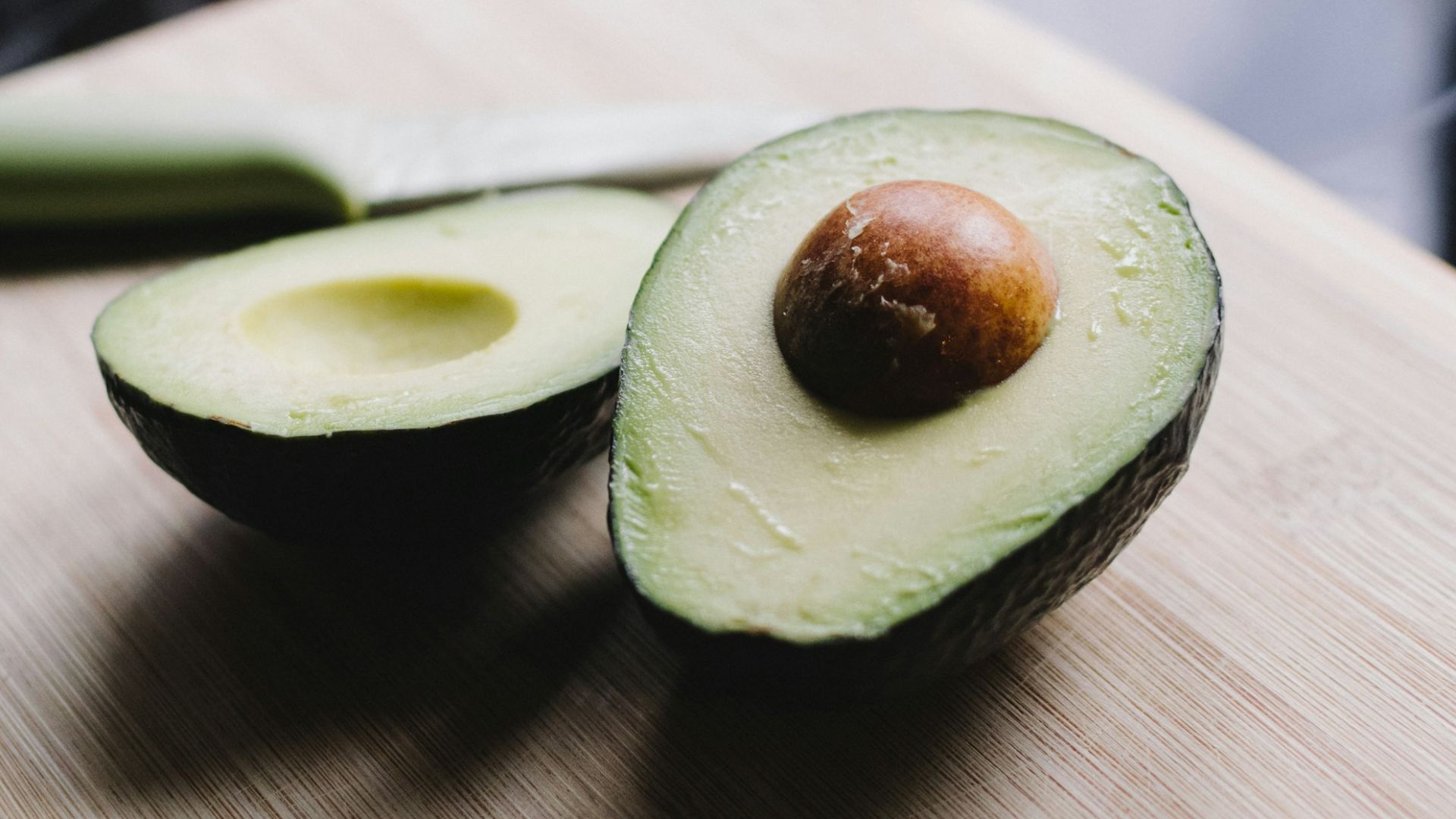 sliced avocado on brown wooden chopping board